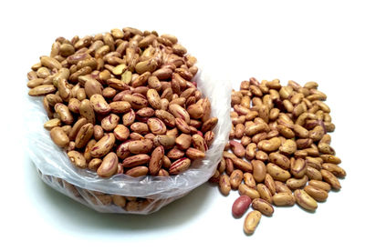 Close-up of roasted coffee beans against white background