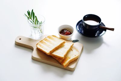 Close-up of breakfast on table against white background