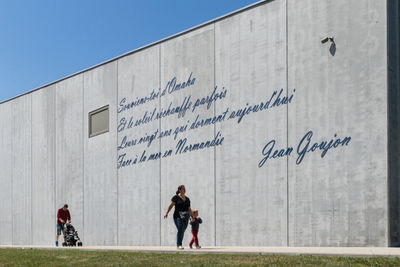 Young woman with text on wall