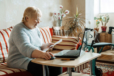 Man sitting on chair at table