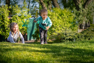 Happy sblings playing on grass