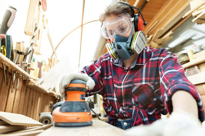 Side view of man working in workshop