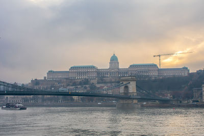 View of bridge over river against sky during sunset