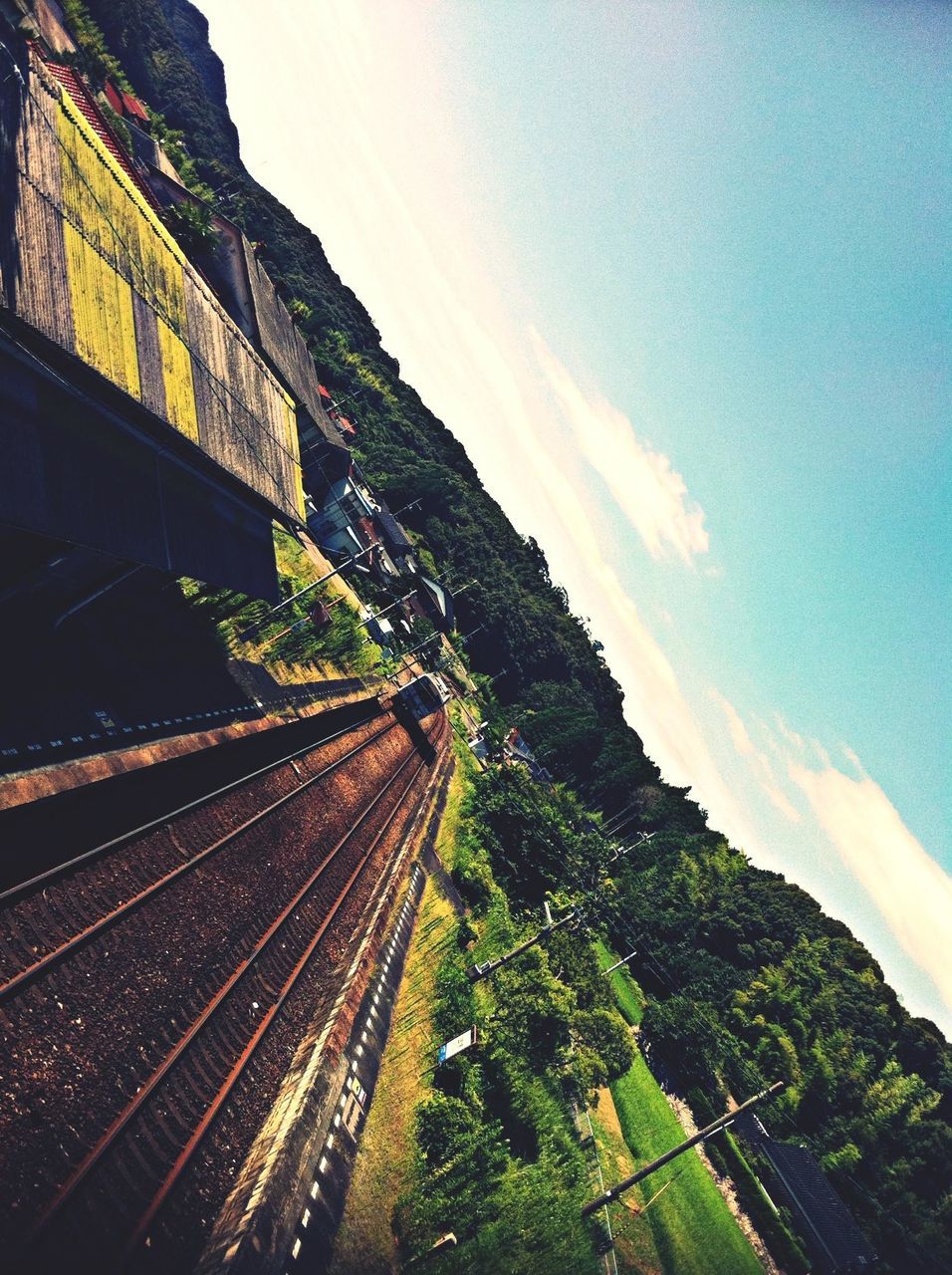 the way forward, transportation, railroad track, sky, diminishing perspective, vanishing point, rail transportation, mountain, tree, road, tranquility, landscape, nature, cloud - sky, blue, tranquil scene, high angle view, outdoors, no people, day