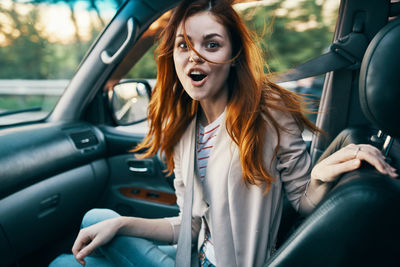 Portrait of woman sitting in car