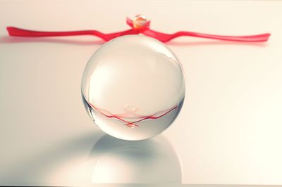 Close-up of red cup over white background