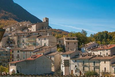 Buildings in town against sky