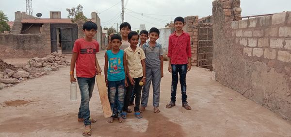 Group of people on road against built structure