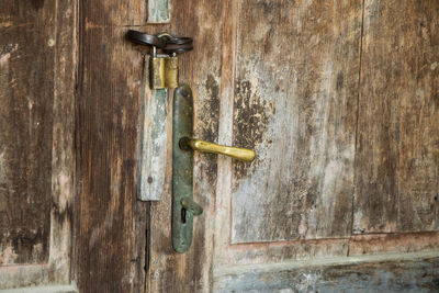 Close-up of padlock on wooden door