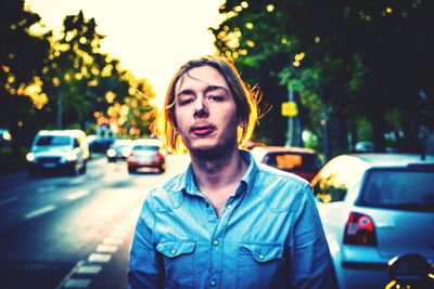 Portrait of young man standing on road