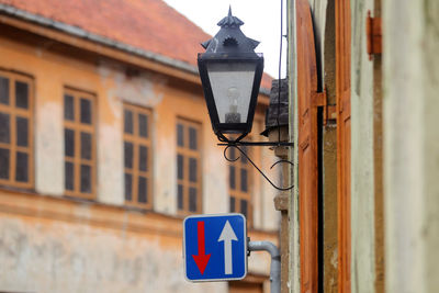 Low angle view of street light against building