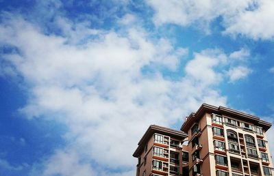 Low angle view of building against cloudy sky