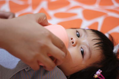 Portrait of cute baby lying on bed