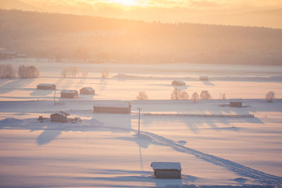 Scenic view of snow covered landscape during sunset