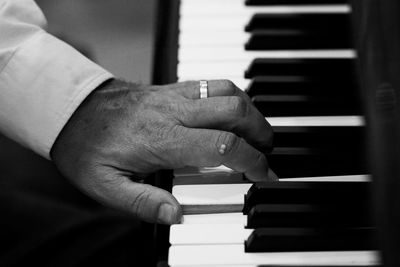 Midsection of man playing piano