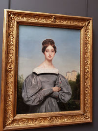 Portrait of young woman standing at home