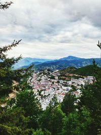 Scenic view of mountains against cloudy sky