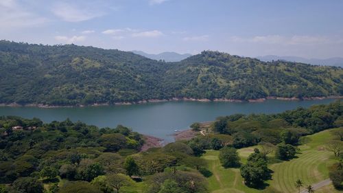 Scenic view of lake and trees against sky