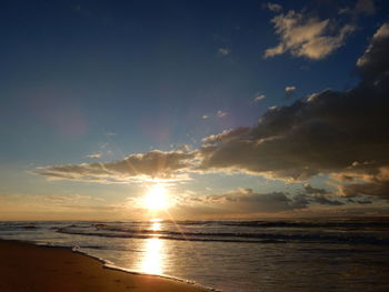 View of calm beach at sunset