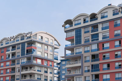 Colorful residential complex of several houses against the sky.