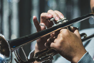 Cropped hands playing musical instrument