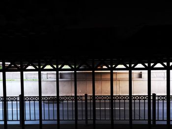 Illuminated building seen through window at sunset