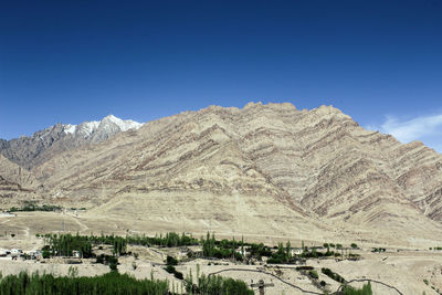 Scenic view of mountains against clear blue sky