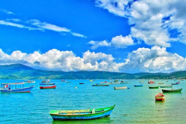 nautical vessel, boat, transportation, water, mode of transport, sky, moored, sea, waterfront, tranquil scene, cloud - sky, tranquility, mountain, scenics, cloud, blue, beauty in nature, nature, cloudy, travel