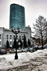 View of city street against cloudy sky