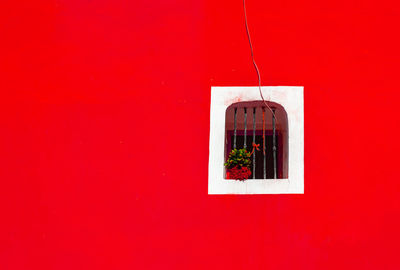 Window on red wall