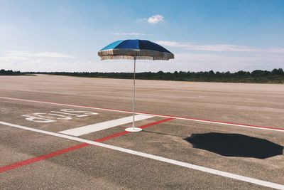 Parasol on playing field during sunny day