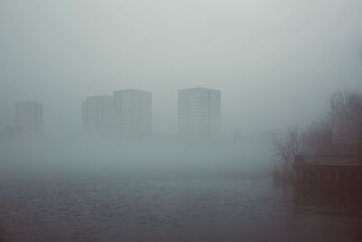 Scenic view of city during foggy weather