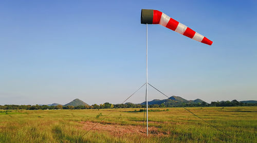 Windmill on field against clear sky