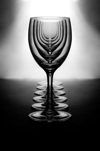 Close-up of drinking glass on table against wall