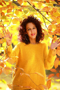 Portrait of young woman with autumn leaves