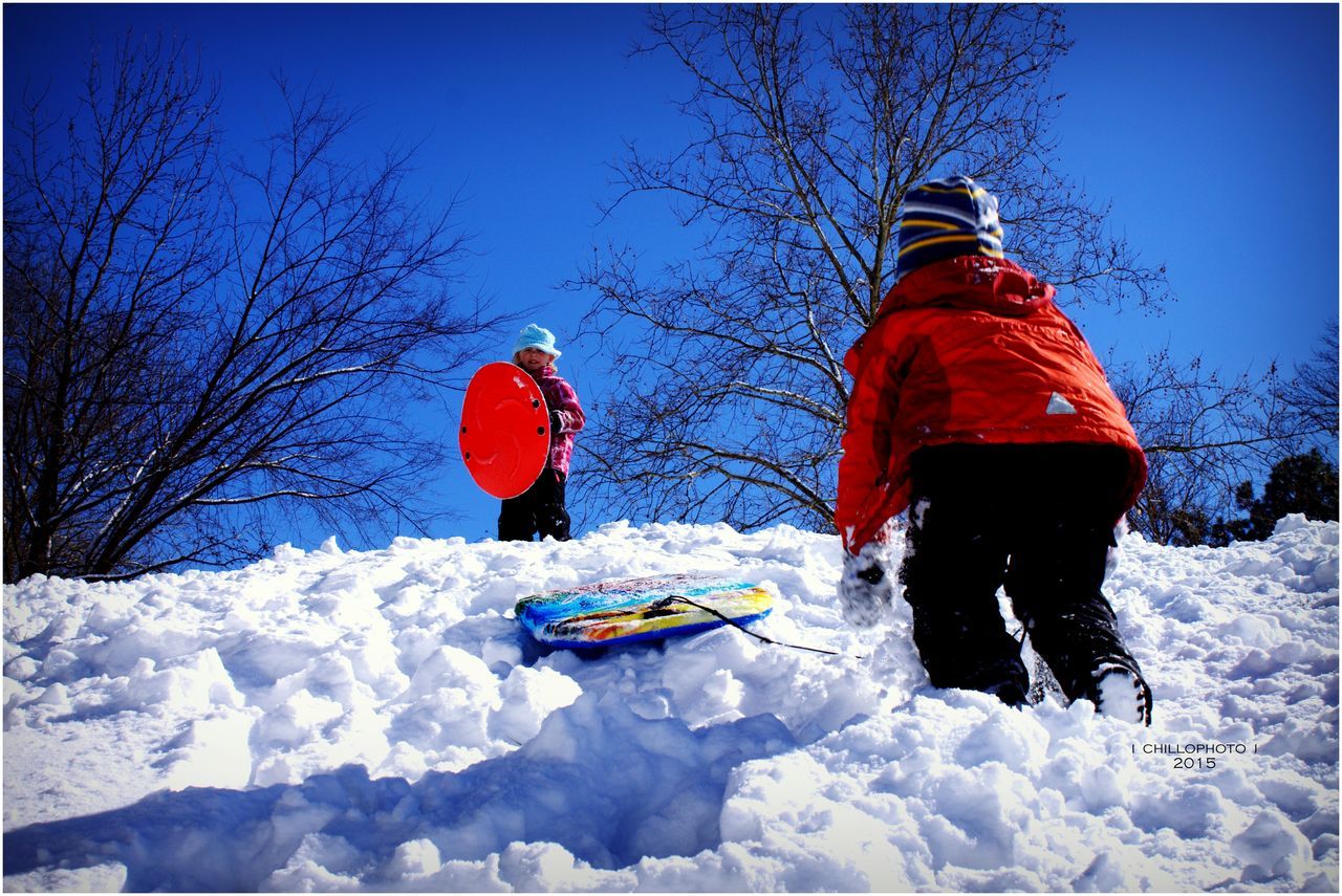 snow, winter, cold temperature, season, bare tree, weather, covering, clear sky, leisure activity, adventure, field, tree, full length, blue, landscape, lifestyles, warm clothing, nature, covered