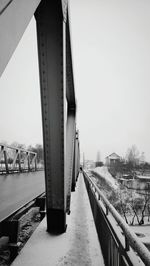 Footbridge over river against clear sky