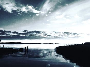 Scenic view of lake against cloudy sky