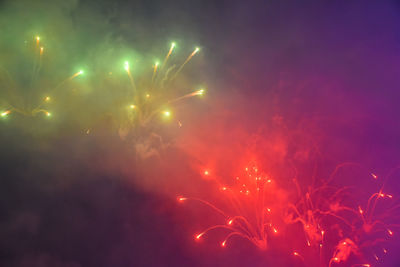 Low angle view of firework display at night