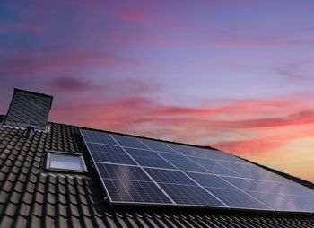 Solar panels against sky during sunset