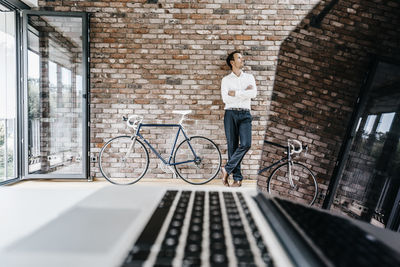 Businessman with bicycle in office