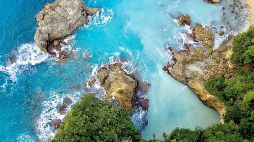 High angle view of rocks on sea shore