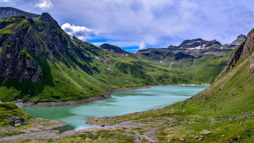 Scenic view of lake and mountains against sky