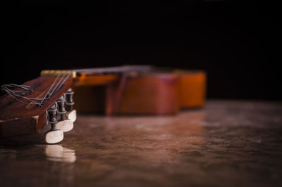 Close-up of guitar on table