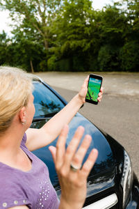 Cropped image of woman holding camera