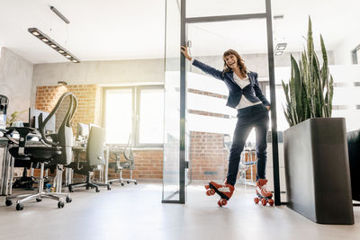 Successful businesswoman wearing roller skates in office