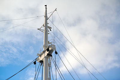 Sailing mast of ship on blue cloudy sky background, copy space. sailing vessel main topgallant mast