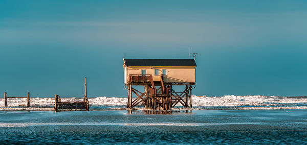 Pile dwelling on the beach of sankt peter-ording in germany.