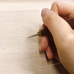 Close-up of person hand on table