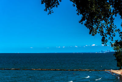 Scenic view of sea against clear blue sky